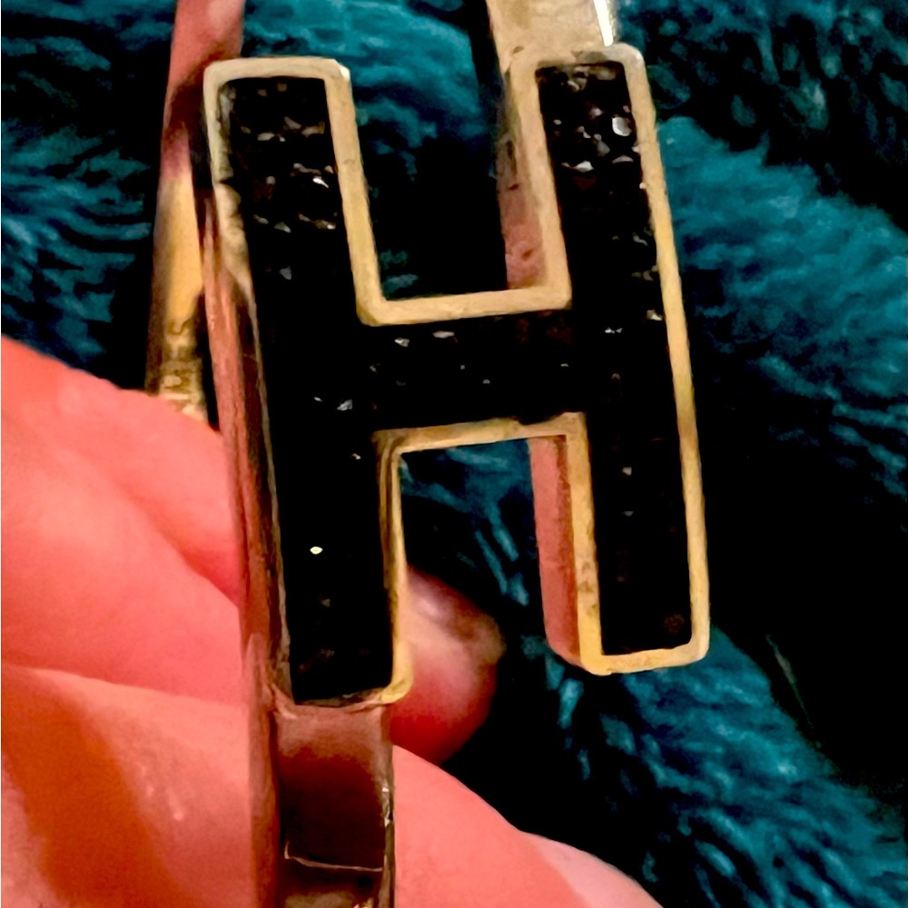 Unbranded black crystal “H” on silver bangle bracelet.